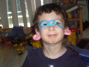 Tyler modeling what else you can do with Mr. Potato Head accessories, plus part of the load of toys behind him!