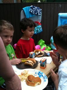 Tyler and his friends, at the little table, enjoying the EATS!